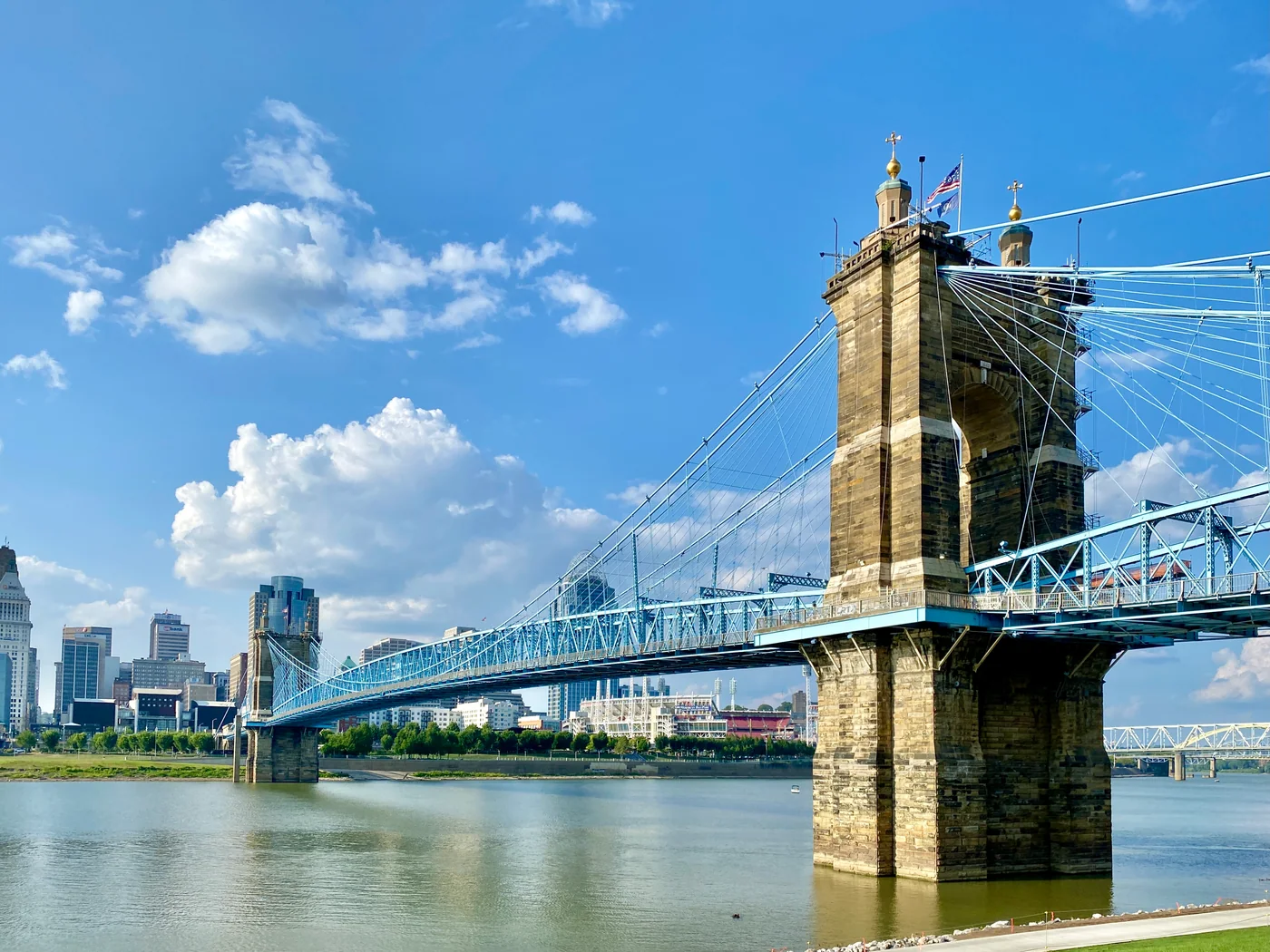 The Roebling Suspension Bridge crossing the Ohio River with Cincinnati buildings beyond.