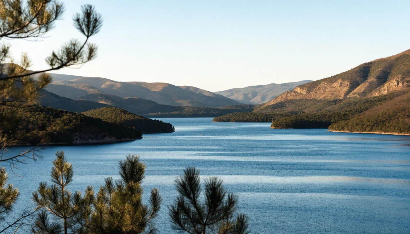 Blue lake and layered wooded hills in a Virginia foothills scene.